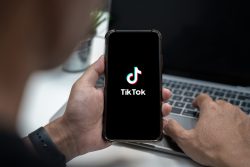 Closed up image of a male using tiktok application on a smartphone